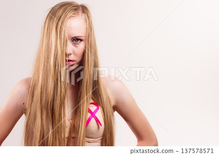 Woman chest in bra, pink cancer ribbon Woman chest in bra, pink cancer ribbon 137578571