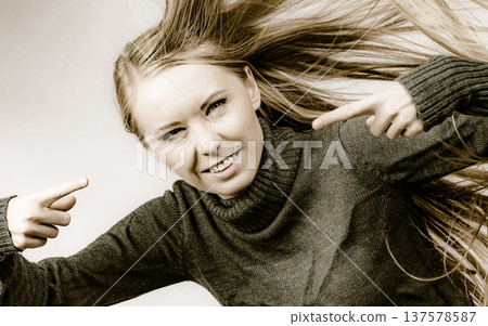 Angry girl with blowing hair Angry girl with blowing hair 137578587