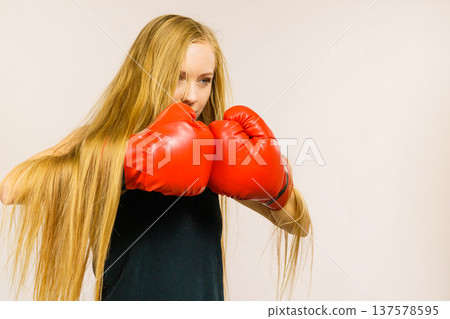 Woman in gloves playing sports boxing Woman in gloves playing sports boxing 137578595
