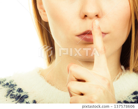 Young blonde woman making silence gesture 137578606