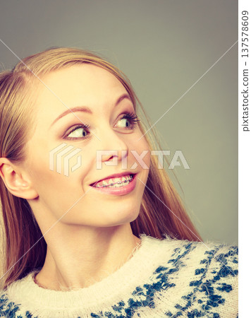 Happy woman showing her braces on teeth 137578609