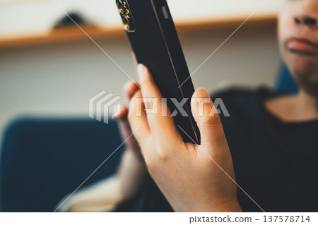 A woman playing with a smartphone 137578714
