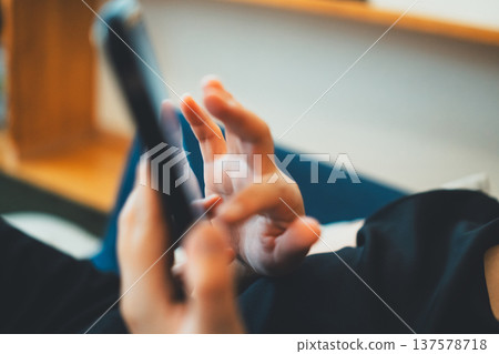 A woman playing with a smartphone 137578718