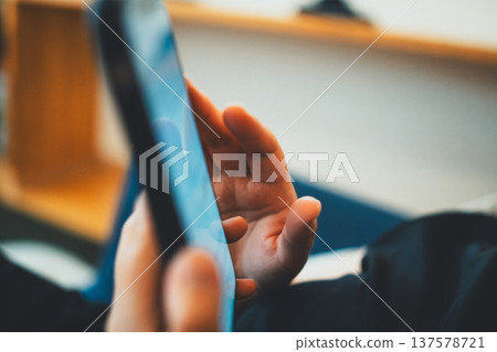 Housewife operating a smartphone Housewife operating a smartphone 137578721