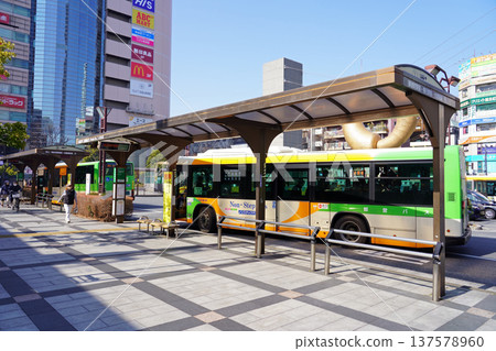 A Toei bus stops at the rotary at the north exit of JR Kinshicho Station on a sunny day A Toei bus stops at the rotary at the north exit of JR Kinshicho Station on a sunny day 137578960