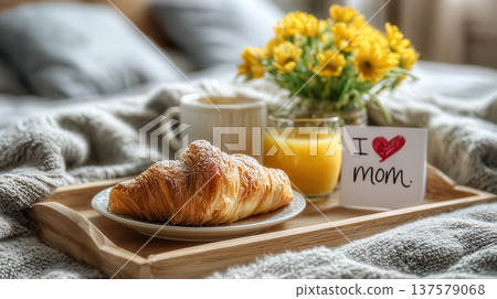 Breakfast in bed with croissant coffee orange juice flowers and greeting card for mother day celebration 137579068