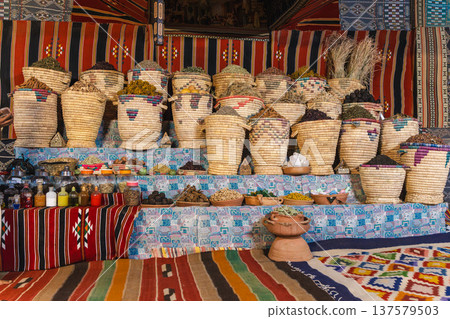 Traditional Egyptian market stall with herbal teas spices and medicinal herbs in woven baskets 137579503
