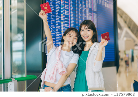 Two women holding passports at the airport. (Photography courtesy of Kansai International Airport (KIX)) Two women holding passports at the airport. (Photography courtesy of Kansai International Airport (KIX)) 137579908