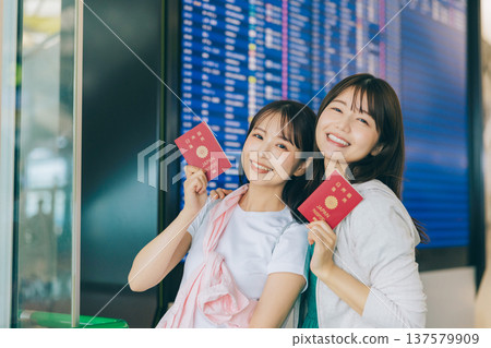Two women holding passports at the airport. (Photography courtesy of Kansai International Airport (KIX)) Two women holding passports at the airport. (Photography courtesy of Kansai International Airport (KIX)) 137579909