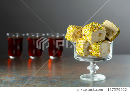 Turkish delights with black tea on a dark background. Turkish delights with black tea on a dark background. 137579922