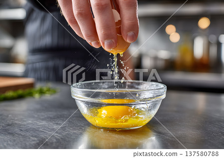 Egg hand kitchen cooking chef raw yolk protein breakfast bowl crack shell ingredient preparation utensil stainless counter closeup splash drop liquid food fresh gastronomy recipe meal cuisine 137580788