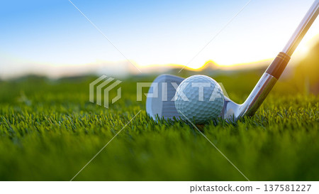 Golf clubs and balls on a green lawn in a beautiful golf course with morning sunshine. Golf clubs and balls on a green lawn in a beautiful golf course with morning sunshine. 137581227