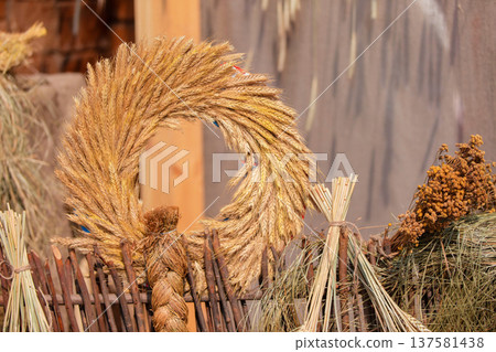 Decorative wreath made of natural materials displayed at a rustic setting in late afternoon light Decorative wreath made of natural materials displayed at a rustic setting in late afternoon light 137581438