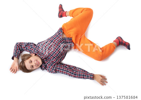 A teenage boy walks eccentrically. He is depicted with his head down. A teenage boy walks eccentrically. He is depicted with his head down. 137581684