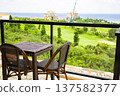 A view of the golf course and ocean from the hotel terrace table and chairs, a tropical resort scene (Miyakojima City, Okinawa Prefecture) 137582377