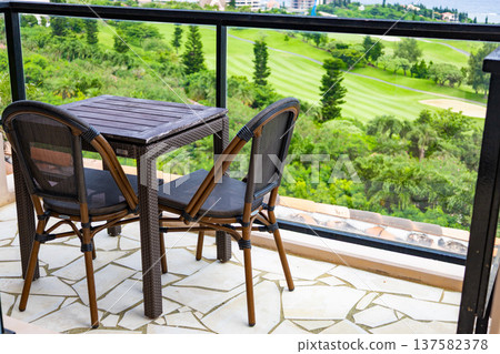 A view of the golf course and ocean from the hotel terrace table and chairs, a tropical resort scene (Miyakojima City, Okinawa Prefecture) A view of the golf course and ocean from the hotel terrace table and chairs, a tropical resort scene (Miyakojima City, Okinawa Prefecture) 137582378