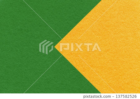Textured green paper background with yellow arrow, macro. Template with copy space for banner, presentation 137582526