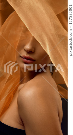 Cinematic portrait of Asian woman emerging through golden silk fabric Cinematic portrait of Asian woman emerging through golden silk fabric 137583001