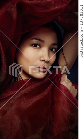Fashion beauty portrait of Asian woman wrapped in red translucent silk fabric Fashion beauty portrait of Asian woman wrapped in red translucent silk fabric 137583011