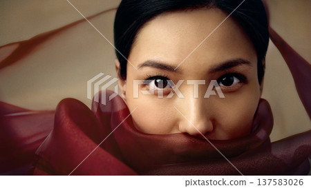 Beauty portrait of Asian woman with red silk fabric covering lower face 137583026