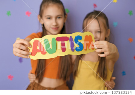 Happy, friendly children show the colorful inscription autism on the card. The doctrine of equality and tolerance and mutual assistance 137583154