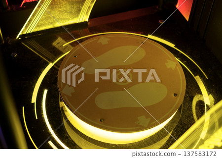 A button for an outdoor dance game with arrows in an amusement park. Repeat the dance game A button for an outdoor dance game with arrows in an amusement park. Repeat the dance game 137583172