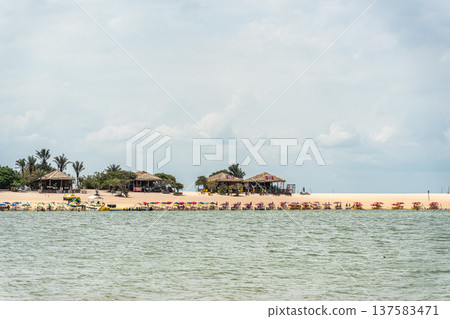 Alter do Chao, Brazil - Dec 15, 2025: Umbrellas color the beach of Ilha do Amor in Alter do Chao, Brazil Alter do Chao, Brazil - Dec 15, 2025: Umbrellas color the beach of Ilha do Amor in Alter do Chao, Brazil 137583471