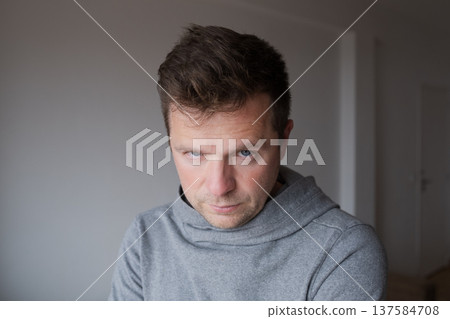 Mid Shot Emotional Portrait of a Middle Aged Man Looking Reproachfully at the Camera 137584708
