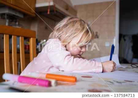 Little 4 Year Old Girl Learning to Write Letters in the Kitchen 137584713