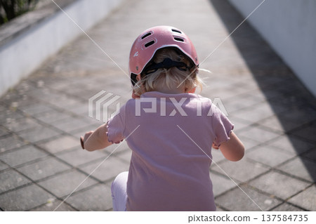 Little Girl Learning to Ride a Bicycle Little Girl Learning to Ride a Bicycle 137584735