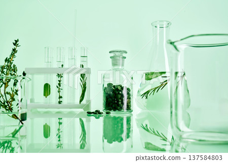Natural plant extracts developing in laboratory glassware 137584803