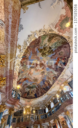 Grand library in Wiblingen Abbey, Ulm, Germany. Baroque interior with ornate columns, frescoed ceilings, and shelves filled with books. 137585056
