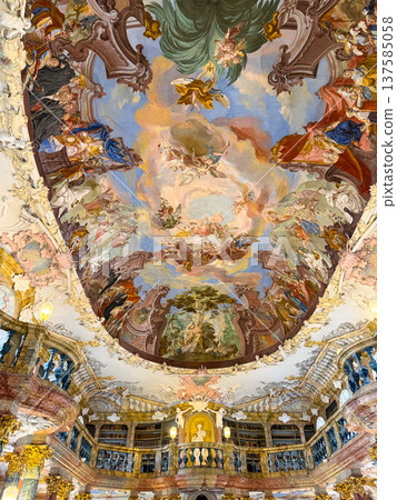 Grand library in Wiblingen Abbey, Ulm, Germany. Baroque interior with ornate columns, frescoed ceilings, and shelves filled with books. Grand library in Wiblingen Abbey, Ulm, Germany. Baroque interior with ornate columns, frescoed ceilings, and shelves filled with books. 137585058