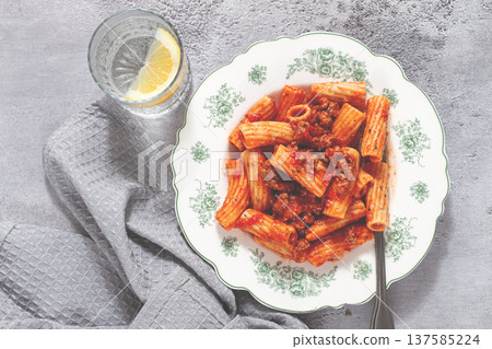 Rigatoni pasta with meat sauce and parmesan cheese on a light table, top view, homemade, no people, Rigatoni pasta with meat sauce and parmesan cheese on a light table, top view, homemade, no people, 137585224