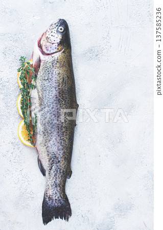 Freshly caught rainbow trout with herbs and citrus arranged on a light textured surface Freshly caught rainbow trout with herbs and citrus arranged on a light textured surface 137585236