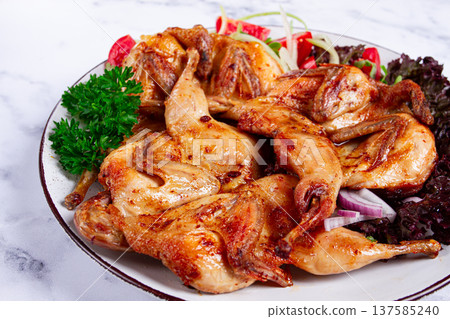 Baked quail, served on a plate with crispy lettuce leaves, fresh tomatoes and herbs, on a white plate, homemade, Baked quail, served on a plate with crispy lettuce leaves, fresh tomatoes and herbs, on a white plate, homemade, 137585240