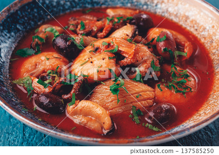 seafood in tomato sauce with olives, on a dark blue background, seafood in tomato sauce with olives, on a dark blue background, 137585250