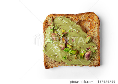 slices of toasted bread, topped with pistachio paste, and sprinkled with pistachios, on a white background, isolate, slices of toasted bread, topped with pistachio paste, and sprinkled with pistachios, on a white background, isolate, 137585255