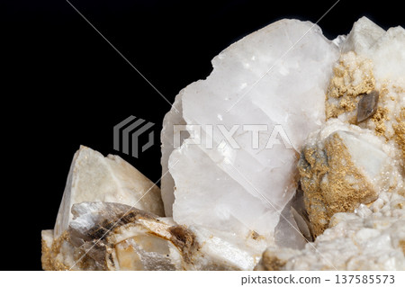 Macro mineral stone Snow quartz with calcite on a black background Macro mineral stone Snow quartz with calcite on a black background 137585573