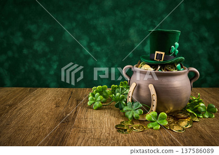 St. Patrick's day pot of gold with shamrocks and horseshoe St. Patrick's day pot of gold with shamrocks and horseshoe 137586089