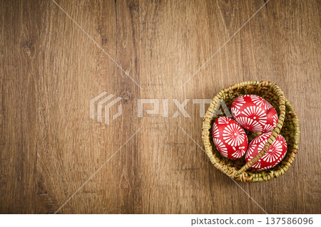 Red easter eggs with floral pattern in basket 137586096