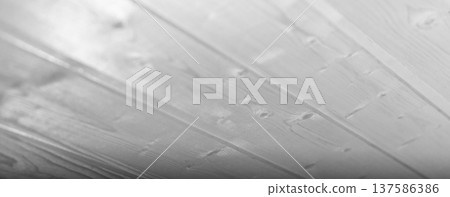 Close-up view of white wooden planks of ceiling, showcasing smooth glossy grains Close-up view of white wooden planks of ceiling, showcasing smooth glossy grains 137586386