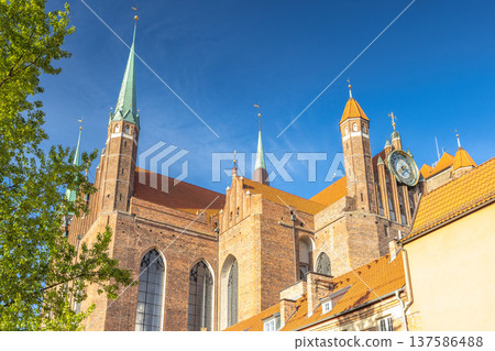St. Mary's Church in Gdansk, a city on the Baltic coast of northern Poland, Europe. Historic European church with towers and spires against a clear blue sky. St. Mary's Church in Gdansk, a city on the Baltic coast of northern Poland, Europe. Historic European church with towers and spires against a clear blue sky. 137586488