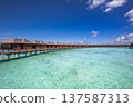 Stunning Maldives luxury water villas overlooking radiant turquoise lagoon idyllic romantic couple destination serene tropical island summer travel paradise 137587313