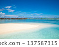 Stunning Maldives luxury water villas overlooking radiant turquoise lagoon beside sandy tropical island shore idyllic romantic couple summer travel paradise 137587315