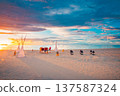 Radiant sunset beach wedding with romantic candles and flowers colorful sky and clouds pristine ocean serene summer landscape perfect honeymoon anniversary destination 137587324