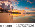 Breathtaking Maldives sunset over ocean bay with luxury water villas radiant turquoise lagoon and dream sky clouds serene tropical summer travel paradise gorgeous vacation landscape 137587326