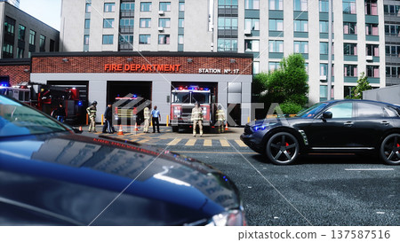 Fire station. A firefighter stands next to a fire engine. Fire trucks, their lights on, are ready to go. 3d rendering. 137587516