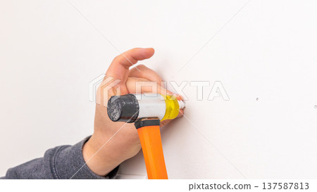 Mans hand holding yellow cordless drill with attached bit near completed wall bracket installation. Home improvement, finishing task, DIY completion, tool holding. Mans hand holding yellow cordless drill with attached bit near completed wall bracket installation. Home improvement, finishing task, DIY completion, tool holding. 137587813