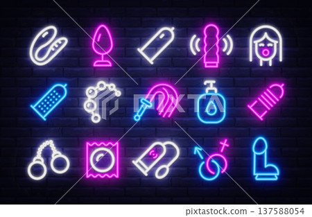 Neon icon set with adult shop symbols glowing in pink, blue, and white on dark brick wall. Bright outlines highlight toys, protection, and playful accessories. 137588054